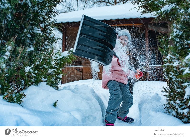 kid girl helping to clean pathway from snow with shovel. Playing Winter Snow House (Residential Structure) Garden Child Tool Weather Storm Snowfall Happiness