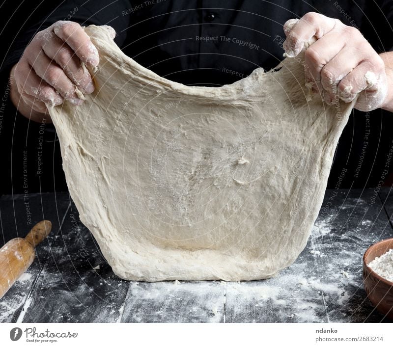 Chef in black jacket, kneads dough Dough Baked goods Bread Nutrition Table Kitchen Cook Human being Man Adults Hand Wood Make Black White Tradition Baking Baker