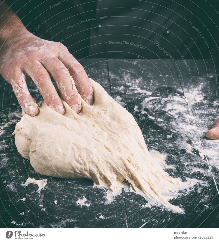 Chef in black jacket kneads dough Dough Baked goods Bread Nutrition Skin Table Kitchen Cook Human being Man Adults Hand Wood Make Black White Tradition Baking