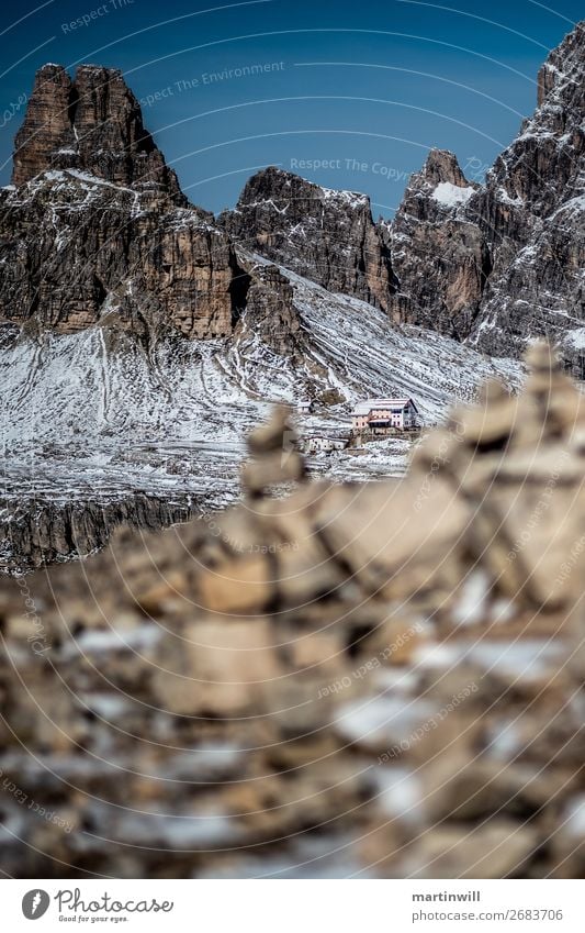 Three merlons hut between Steinmännchen Snow Mountain Hiking Autumn Rock Alps Peak Stone Threat Three peaks Alpine hut Hut Cairn Dolomites Colour photo