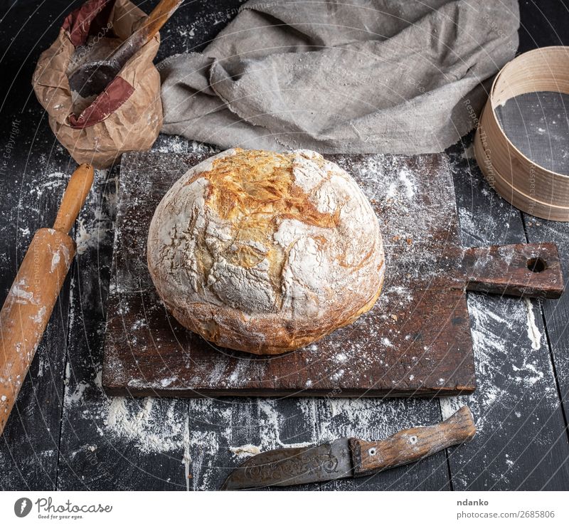 baked bread Dough Baked goods Bread Knives Spoon Table Kitchen Sieve Wood Make Dark Fresh Above Brown Black White Tradition recipe Preparation Baking Bakery