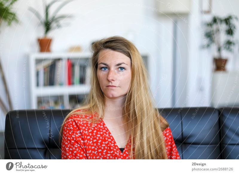 Portrait of serious young woman sitting on sofa Lifestyle Happy Beautiful Calm Leisure and hobbies House (Residential Structure) Sofa Human being Feminine