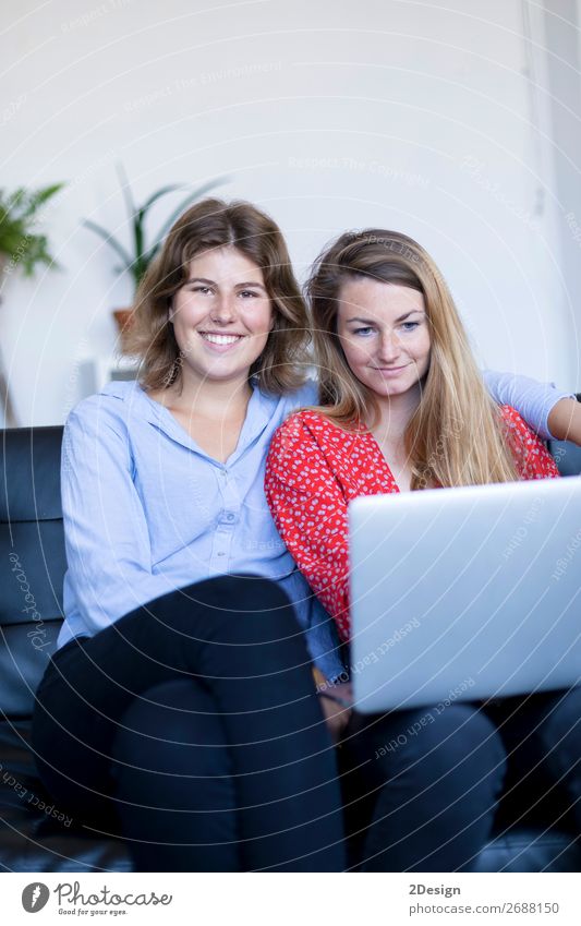 Two smiling young woman sitting on the sofa with laptop. Lifestyle Happy Beautiful House (Residential Structure) Sofa Work and employment Computer Notebook