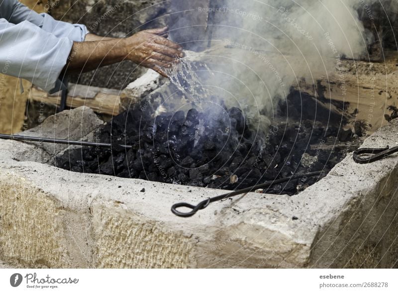 Turning off flames with water in the coal Lunch Beautiful Work and employment Hand Old Fresh Hot Natural Black White Protection Colour Testing & Control