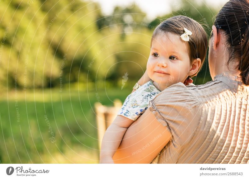 Back view of mother holding baby girl in her arms Lifestyle Joy Happy Beautiful Face Relaxation Summer Child Baby Toddler Woman Adults Parents Mother