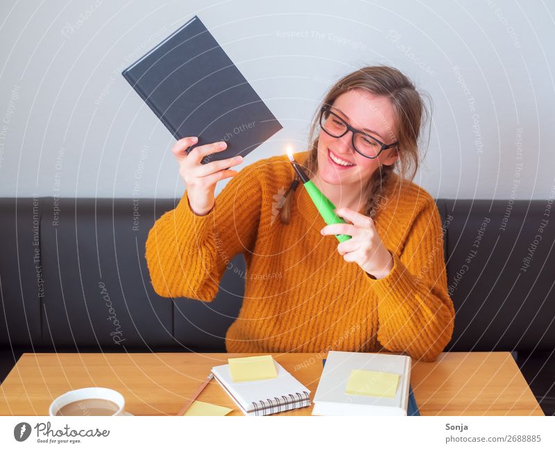 Student lights a book with joy Hot drink Joy Living or residing Table Study University & College student Young woman Youth (Young adults) 1 Human being