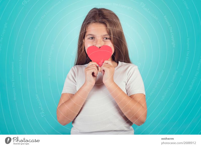 smiling girl with a heart covering her lips on blue background Lifestyle Joy Feasts & Celebrations Valentine's Day Mother's Day Human being Feminine Girl