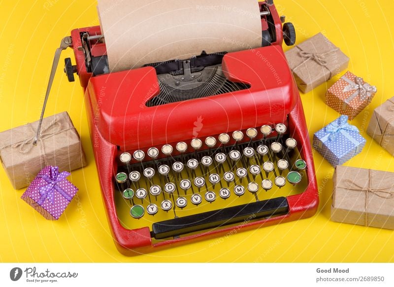 red typewriter with blank craft paper, gift boxes on yellow Feasts & Celebrations Thanksgiving Hallowe'en Christmas & Advent Birthday Craft (trade) Business