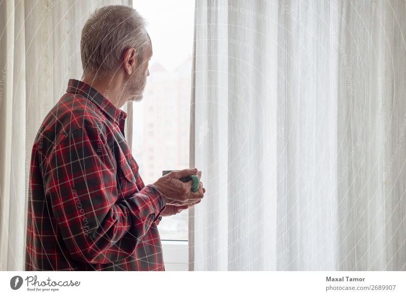 Mature man drinking his coffee and looking out of the window Drinking Coffee Tea Human being Man Adults Town Observe Think Stand Wait Green Red White Caucasian