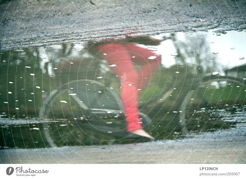 RED CROPS Cycling Bicycle Human being Young woman Youth (Young adults) Woman Adults Legs 1 Environment Summer Bad weather Rain Means of transport