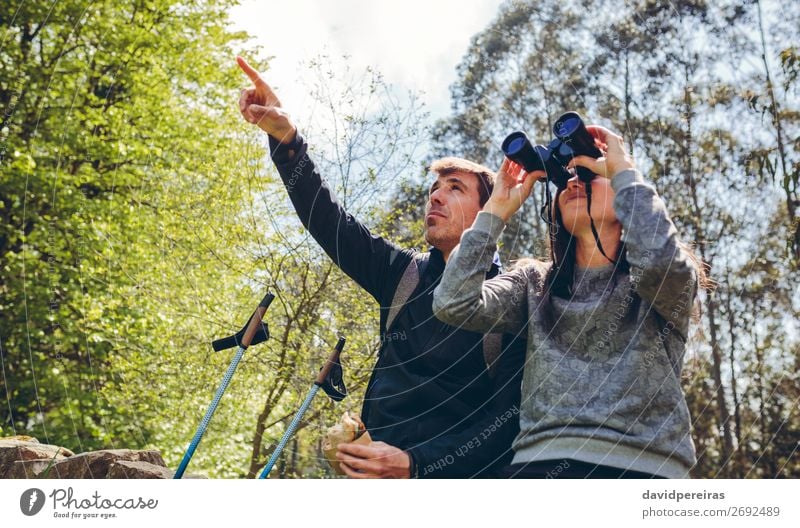 Couple doing trekking looking with binoculars Eating Lifestyle Leisure and hobbies Adventure Hiking Sports Human being Woman Adults Man Nature Landscape Autumn