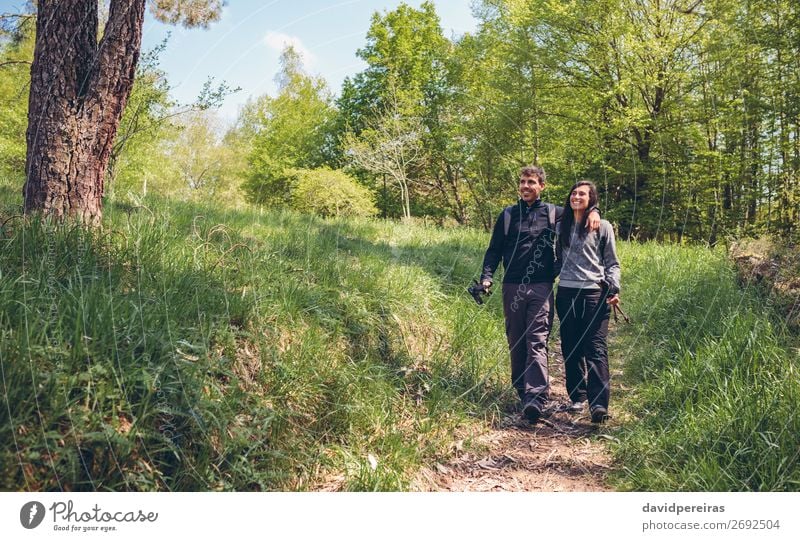 Hikers walking embraced Lifestyle Happy Trip Adventure Hiking Sports Climbing Mountaineering Human being Woman Adults Man Couple Nature Landscape Autumn Tree