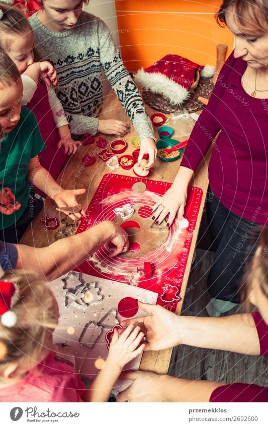 Baking Christmas cookies. Christmas gingerbread cookies in many shapes decorated with colorful frosting, sprinkle, icing, chocolate coating, toppers, put on table. Baking traditional cookies. Family celebrating Christmas. Baking at home. Baked sweet cookie