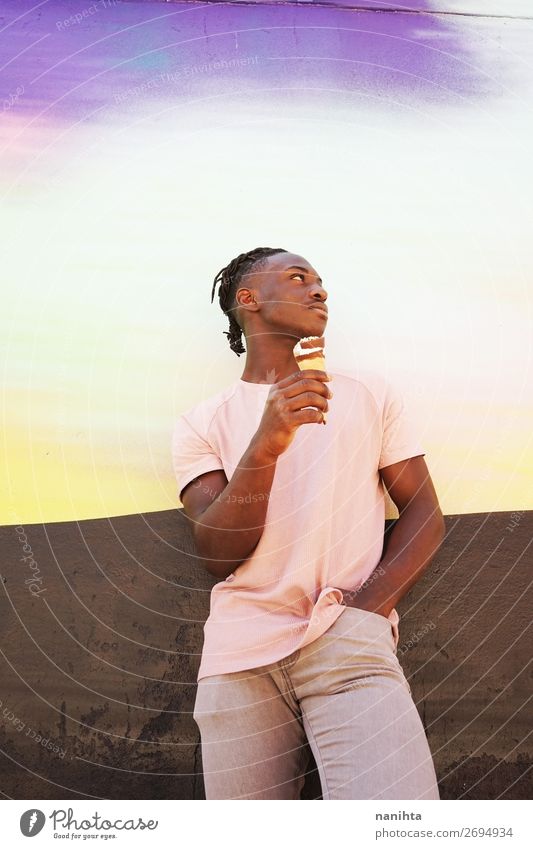 Young handsome black man holds an ice cream cone Ice cream Eating Style Happy Summer Sunbathing Human being Man Adults Youth (Young adults) 1 T-shirt Shirt