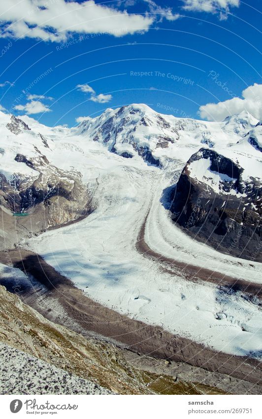 snowy land Hiking Nature Landscape Sky Clouds Climate Climate change Weather Beautiful weather Snow Rock Alps Mountain Peak Snowcapped peak Blue Brown Gray