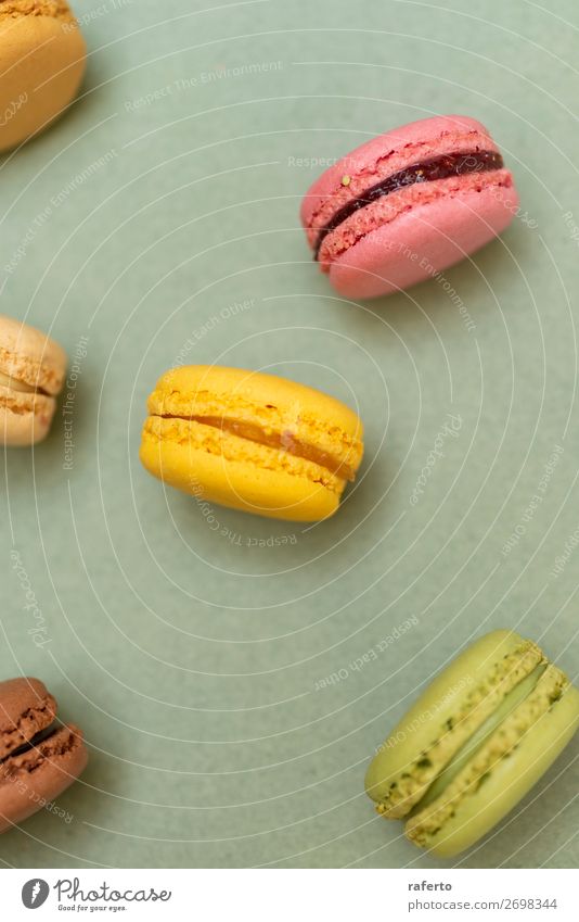 Cake macaroons or macaroons on green background from above Dessert Gastronomy Fresh Bright Delicious Soft Yellow Green Colour 999 OLDER Beaded Orange Purple