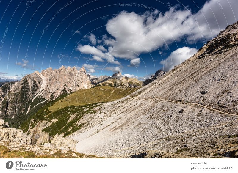 # 798 Three peaks Dolomites Sexten Dolomites World heritage High plain Colour photo Hiking Footpath Peak Mountaineering Alps Beautiful weather Meadow Summer Sun