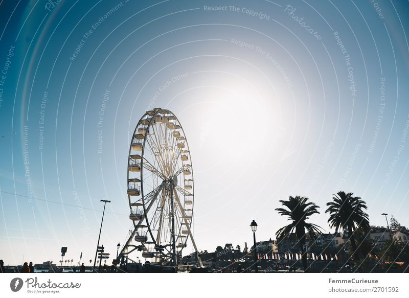 Ferris wheel in front of blue sky Port City Vacation & Travel Vacation destination Cascais Portugal Fairs & Carnivals Attraction Sunbeam Travel photography