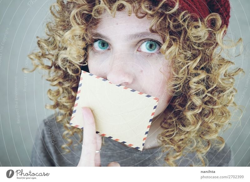 young woman covering her mouth with a letter Style Beautiful Face To talk Human being Feminine Young woman Youth (Young adults) Woman Adults 1 18 - 30 years