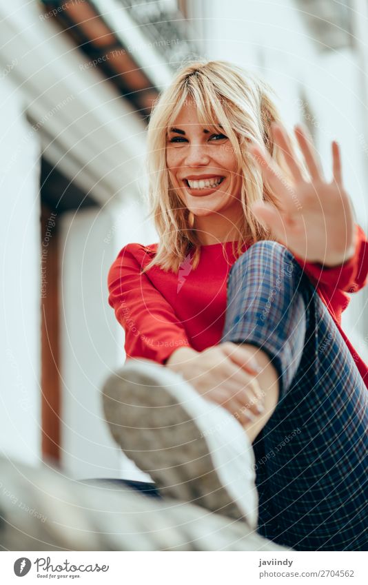 Happy woman sitting outdoors putting her hand near the camera. Lifestyle Style Beautiful Hair and hairstyles Human being Feminine Young woman