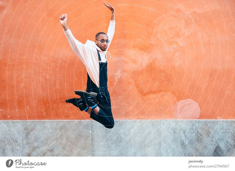 Young black man wearing casual clothes jumping outdoors Lifestyle Joy Happy Beautiful Human being Masculine Young man Youth (Young adults) Man Adults 1