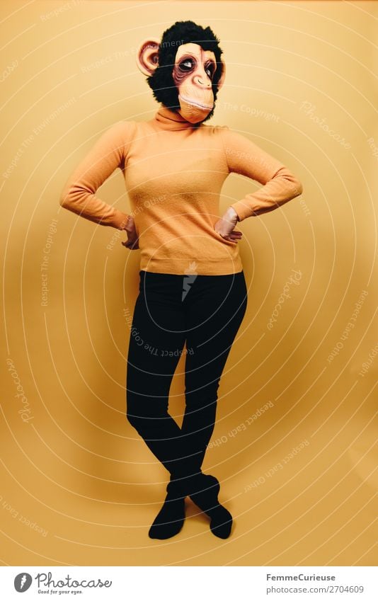 Woman with monkey mask posing against a yellow background Feminine Adults 1 Human being 18 - 30 years Youth (Young adults) 30 - 45 years Joy Monkeys Carnival