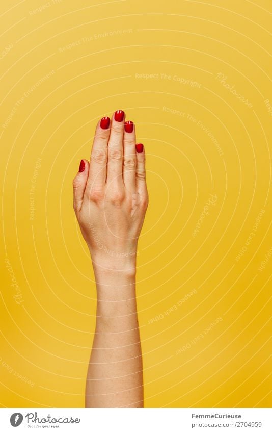 Forearm and hand of a woman in front of a yellow background Feminine Young woman Youth (Young adults) Woman Adults 1 Human being 18 - 30 years 30 - 45 years