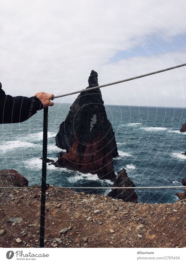 taking a walk on an isle Arm Hand Fingers Landscape Clouds Horizon Waves Coast Ocean Island Rock Barrier Stone Sand Looking Stand Colour photo Exterior shot