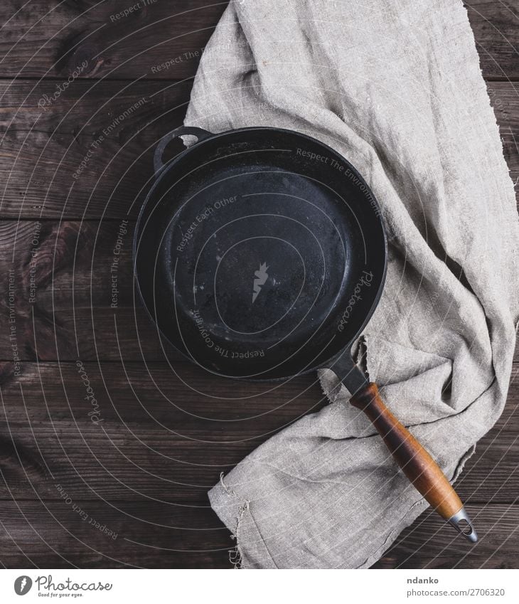 empty black round frying pan with wooden handle Dinner Pan Table Kitchen Wood Metal Old Dark Above Clean Brown Black vintage background board Cast cooking