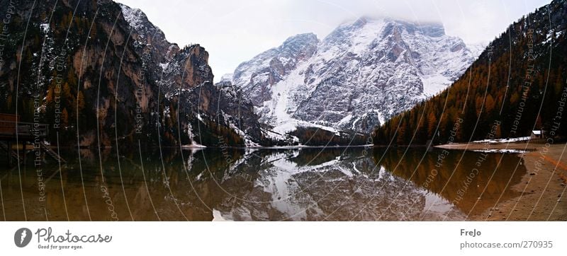 Braies Wild Lake Tourism Trip Winter Snow Environment Nature Landscape Air Water Clouds Bad weather Fog Rock Alps Mountain Snowcapped peak Lakeside