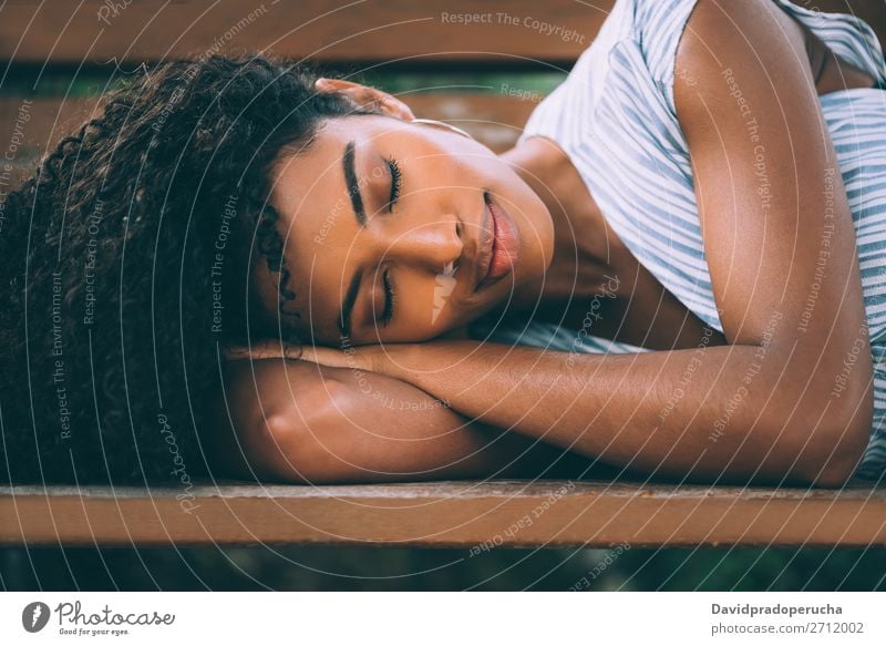 Beautiful young black woman laying down on a chair in a park Woman Beauty Photography Close-up Portrait photograph multiethnic Black African