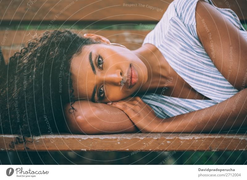 Beautiful young black woman laying down on a chair in a park Woman Beauty Photography Close-up Portrait photograph multiethnic Black African