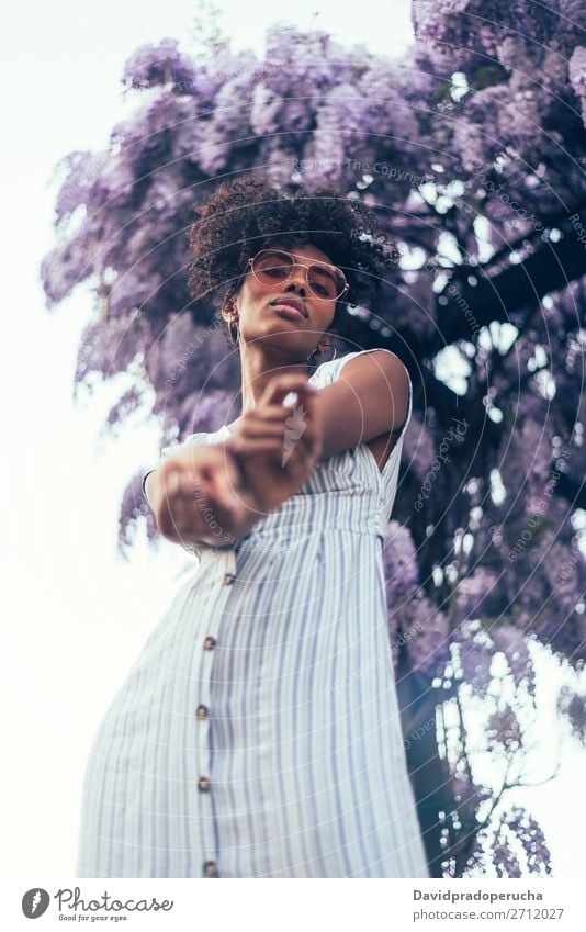 Happy young black woman surrounded by flowers Woman Blossom Spring Lilac Portrait photograph multiethnic Flower Black African Mixed race ethnicity Smiling