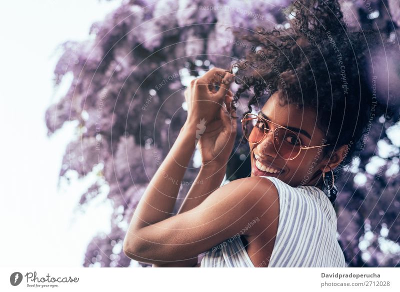 Happy young black woman surrounded by flowers Woman Blossom Spring Lilac Portrait photograph multiethnic Flower Black African Mixed race ethnicity Dance Smiling