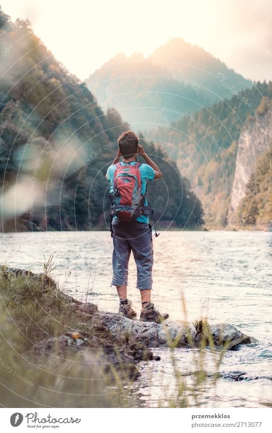 Young tourist with backpack looks through a binoculars Lifestyle Leisure and hobbies Vacation & Travel Tourism Trip Summer Summer vacation Mountain Human being