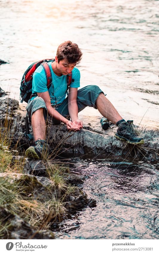 Young boy taking pure water from a river Body Life Hiking Human being Boy (child) Man Adults Hand Environment Nature Lake River Drop Fresh Wet Natural Clean