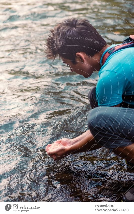 Young boy taking pure water from a river in the hands Body Life Human being Boy (child) Man Adults Hand Environment Nature Lake River Drop Fresh Wet Natural