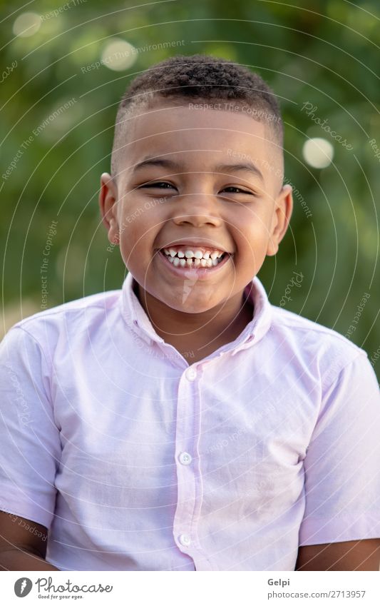 Adorable latin child in the garden with a beautiful green of background Lifestyle Joy Face Playing Garden Child Human being Boy (child) Man Adults Infancy