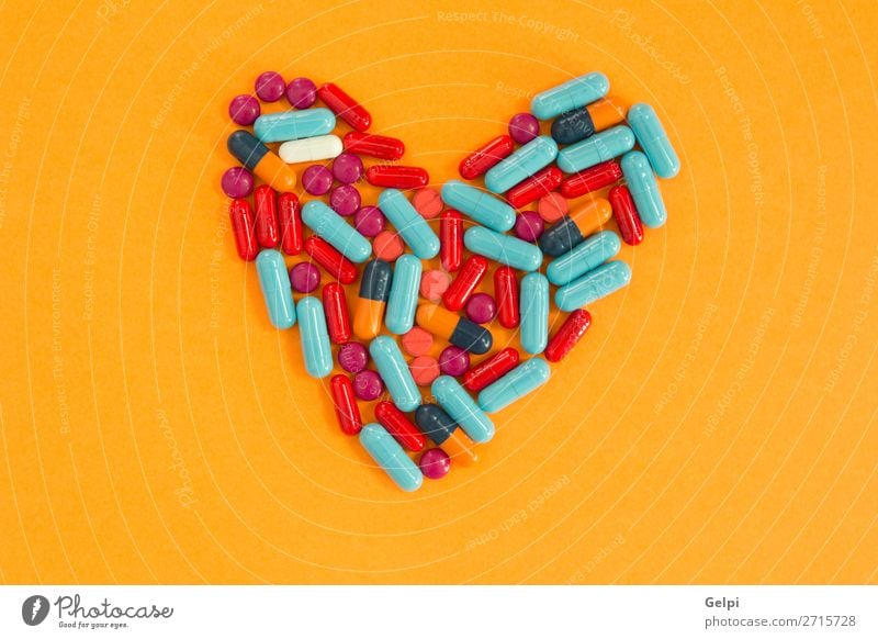 Pills arranged in heart shape on an orange background Bottle Health care Medical treatment Illness Medication Science & Research Hospital Heart Blue White Pain