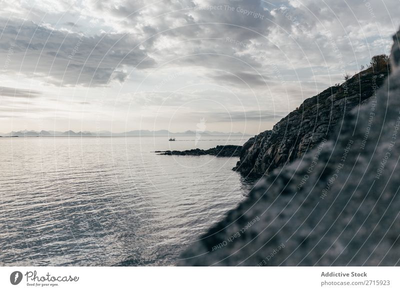 Rocky shore of sea Sunset Nature Ocean Vacation & Travel Sky Cliff Stone Beach Coast Bay Vantage point Beautiful Idyll Picturesque Serene Water Peaceful Calm