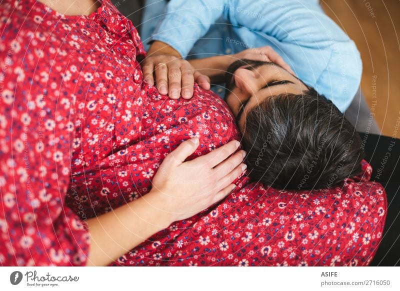 Happy man listening and touching his pregnant wife tummy on the sofa at home Beautiful Body Sofa Baby Woman Adults Man Parents Mother Father Family & Relations