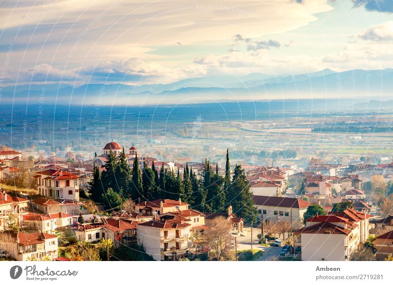 Greek town evening panorama with red roof houses, valley and mountains in the background, Kalambaka, Thessaly, Greece Kalabaka autumn beautiful building church