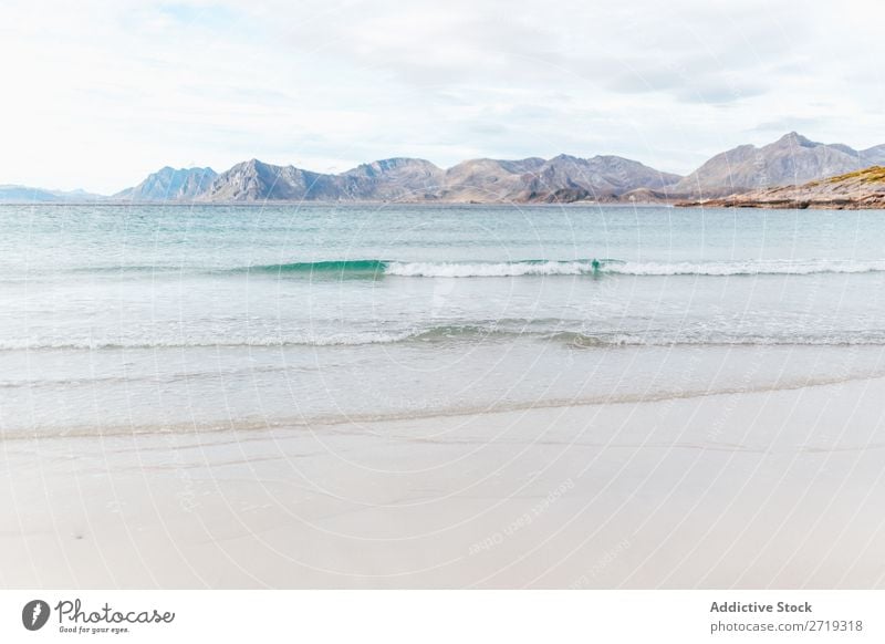 Waves and view to hills Coast Lake Water Hill Mountain Peak Nature Vacation & Travel Vantage point Picturesque Slagheap Landscape Height Rock Adventure