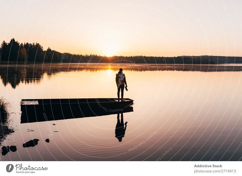 Person on lakeside in morning haze traveler Lake Morning Calm Reflection tranquil Multicoloured Freedom Landscape scenery Vacation & Travel Nature Peaceful