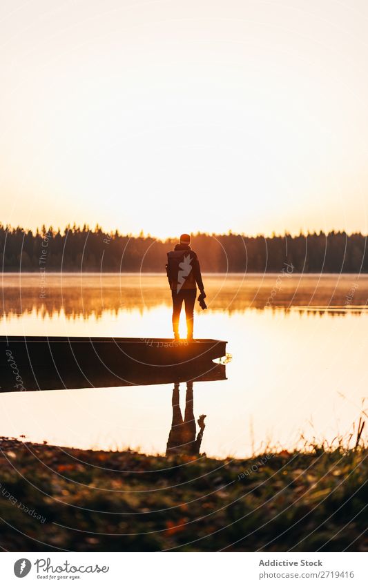 Person on lakeside in morning haze traveler Lake Morning Calm Reflection tranquil Multicoloured Freedom Landscape scenery Vacation & Travel Nature Peaceful