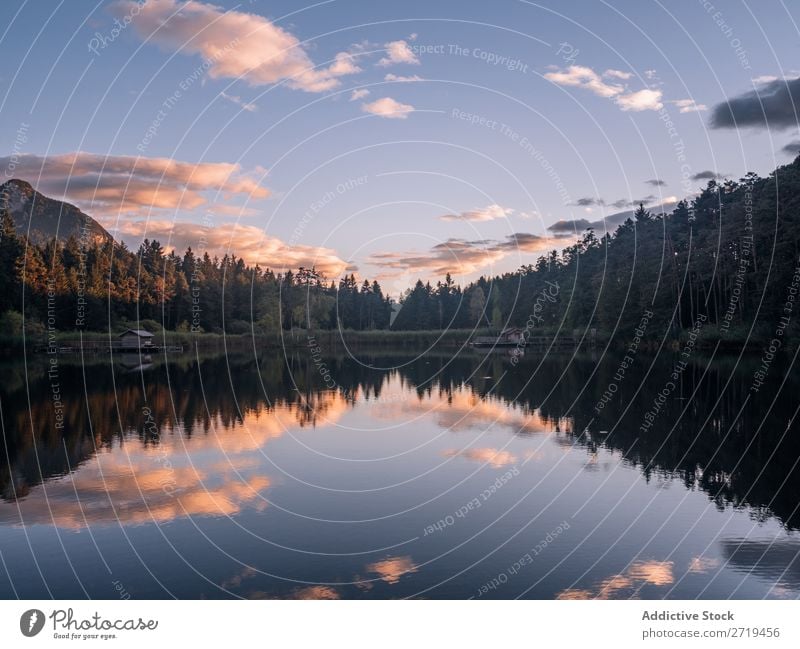 Mirror surface of lake in mountains in Dolomites, Italy Mountain Lake Serene Calm Water Building Landscape Dock Reflection residential