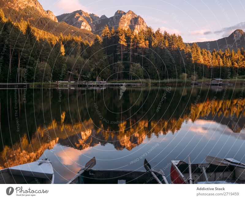 Mirror surface of lake in mountains in Dolomites, Italy Mountain Lake Serene Calm Water Building Landscape Dock Reflection residential