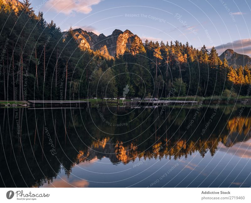 Mirror surface of lake in mountains in Dolomites, Italy Mountain Lake Serene Calm Water Building Landscape Dock Reflection residential