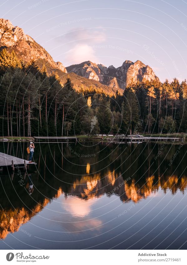 Mirror surface of lake in mountains in Dolomites, Italy Mountain Lake Serene Calm Water Building Landscape Dock Reflection residential