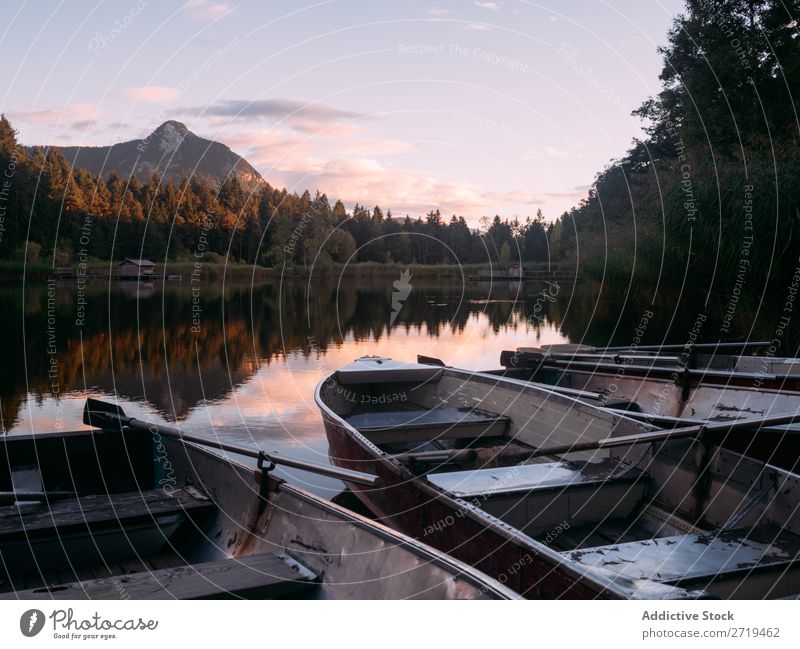 Few boats on shore of lake in Dolomites, Italy Watercraft Coast Lake Mountain Serene Landscape tranquil Peaceful Natural Vacation & Travel Remote enjoyment Calm